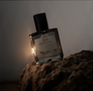 Perfume product shot by candlelight
