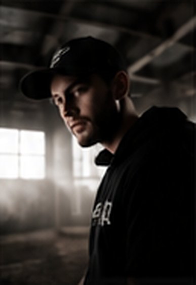 Portrait of a creator in a cap in moody light